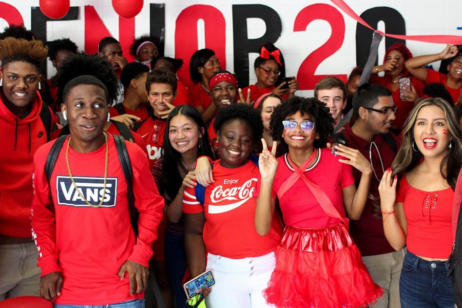 Class of 2020 seniors, above,
decked out in red, gather in
the main hallway during last
year’s Class Color Day