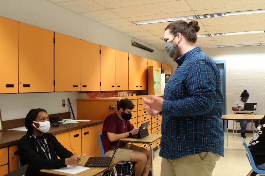 New English 
teacher Chris 
Mosher talks to 
junior Sincere 
Robinson about 
classwork 
on Jan. 26 at 
Lakewood High 
School. “It is 
going awesome; 
the kids are 
great,” Mosher 
said.