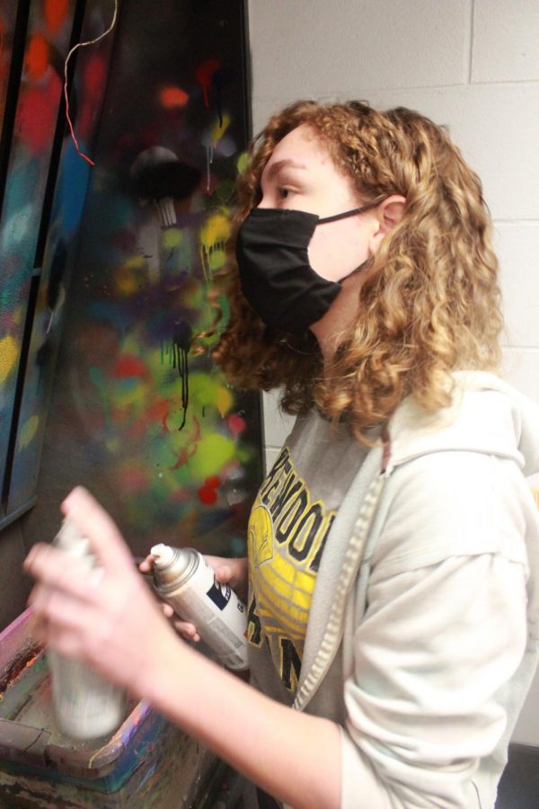 Freshman Siena Van Beynen tests different colors of spray 
paint on the wall on Feb. 10 in 3D art class. 
