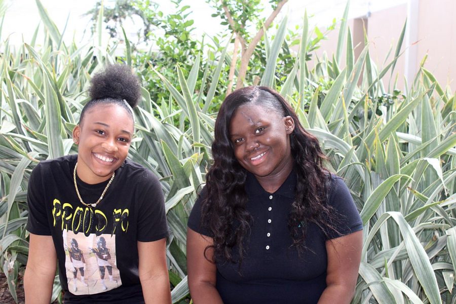 Juniors Tori'el Norwood and Azarria Simmons smile in the school courtyard during spring time. They are happy to have each other after a accident that could've took one from another. 