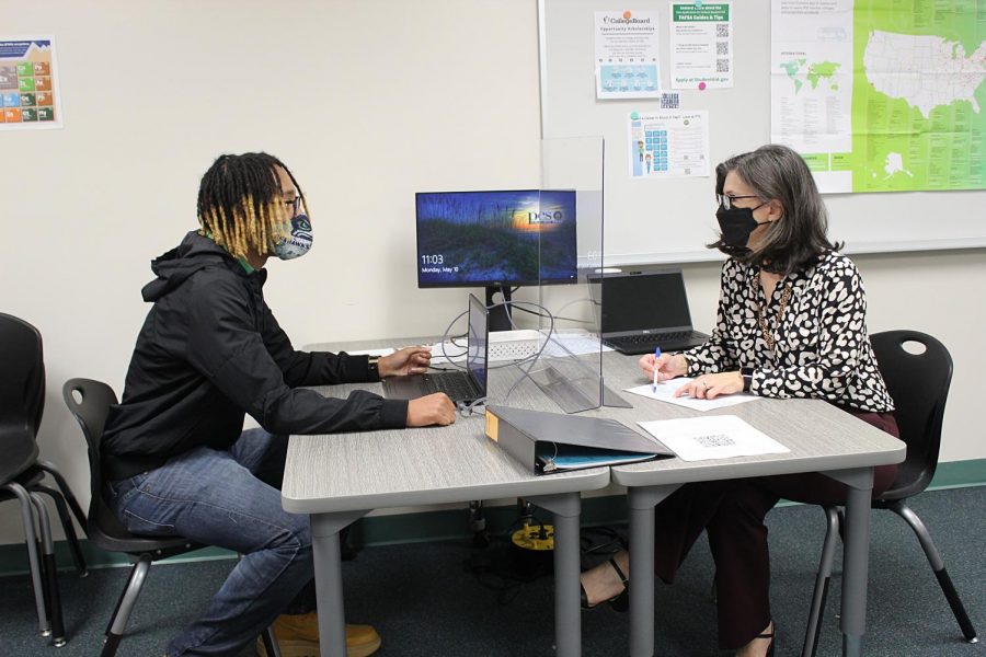 College and career counselor Sarah Alvarez talks to Senior Dajaum Anderson about scholoarships for college.