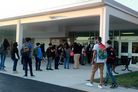 Students arrive to Lakewood on the first day of school, Aug. 11. They wait in line to learn of their first period class.