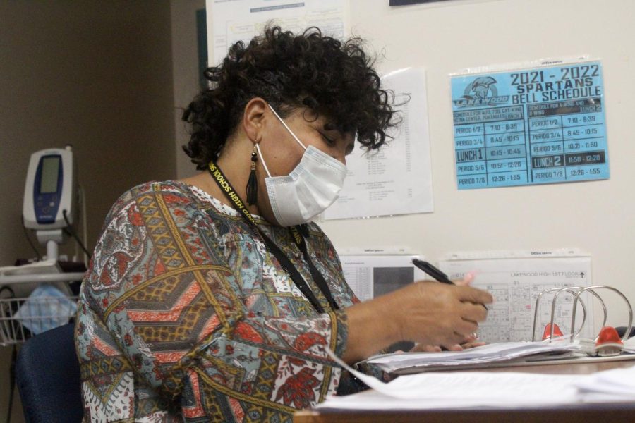 Guidance secretary Dricilla Johnson fills out forms in the clinic office. Johnson has been acting as the school nurse ever since the most recent nurse left. I feel great because I love children and I love taking care of children, Johnson said. 