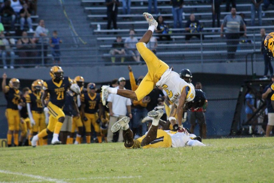 Junior Aviyon Smith-mack jumps over another player during a game against Boga Ciega High School on Aug. 26th. The Spartans beat the Pirates 27-12.