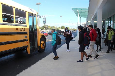 A group of students line up to get on their late bus at the front of Lakewood High School on Dec. 1. 
