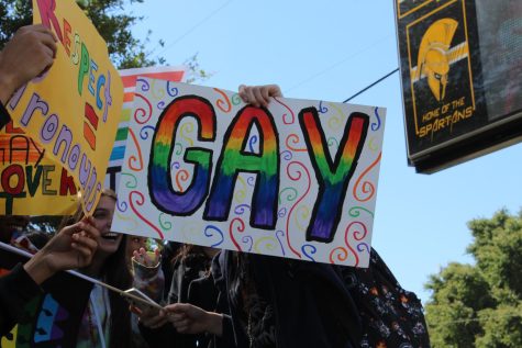 A students holds a sign at the Dont Say Gay rally in front of Lakewood High on March 3.