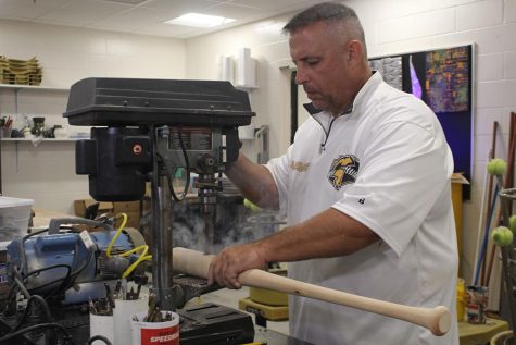 Art teacher Jayce Ganchou uses a drill press to drill a hole into a bat. Ganchou is also the coach for Lakewood Highs baseball team. “In art,” Ganchou said, “you do it, try it, if it doesn’t work, revision.”
