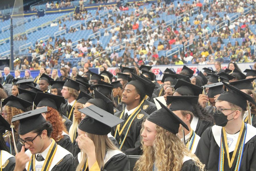 Seniors+of+the+2022+school+year+listen+to+speakers+speak+in+the+Tropicana+Field+for+graduation+May+19%2C+2022.+