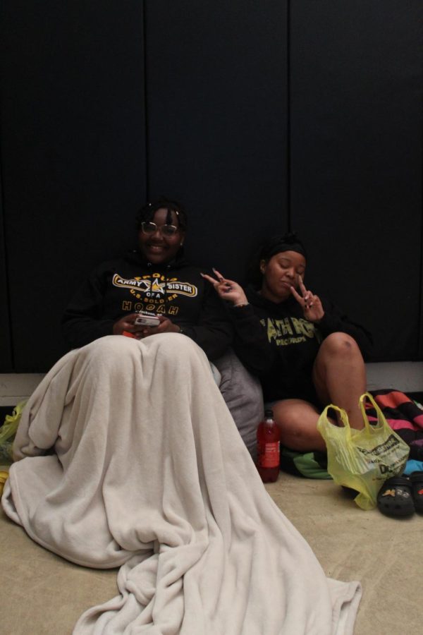 Seniors Erica Henderson and Jalundra Milton sit in the back of the gym during movie night on April 26. 