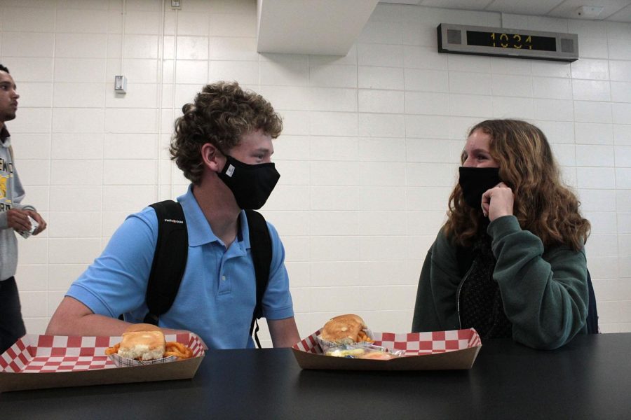 Seniors Ian Navales, left, and Valerie Lambert talk in the cafeteria on Aug. 10. They were discussing some of their first impressions of their teachers for this upcoming school year. Im excited for my UAS class. We get to do really cool projects, Navales said.