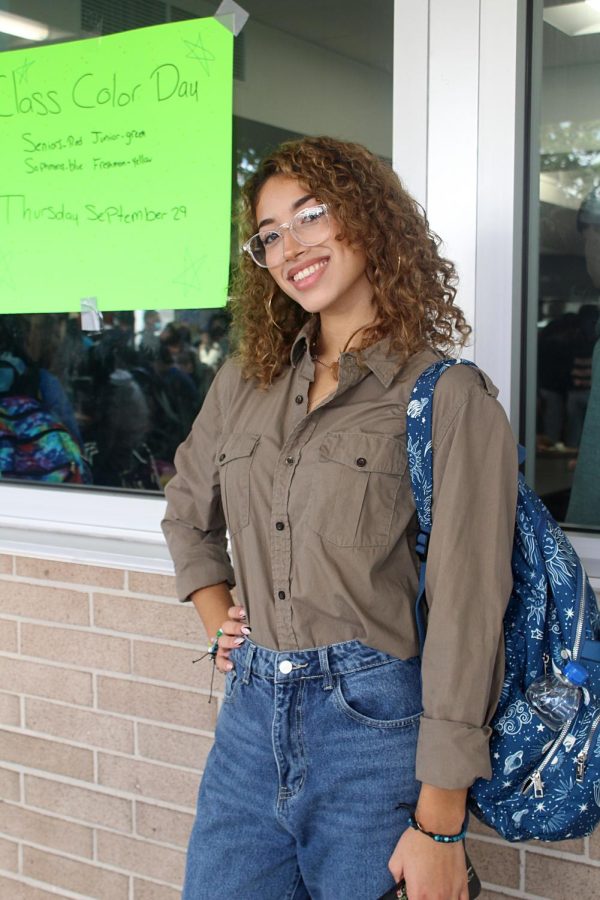 Vice President of SAVE Giselle Galston poses on Sept. 21 at Lakewood High School in front of the cafeteria. Today she is wearing green for the SAVE Promise clubs Say Hello Week. This week is meant for building connections, putting a stop to bullying, and ultimately building a community. 