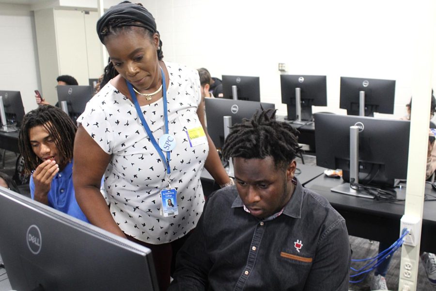 SPC Student Support Advisor Tamica Green assists senior Taveon Wheeler with his St. Petersburg College application on Oct. 11 in room 401. Students who applied on this day got firsthand assistance in this process and their application fee waived.