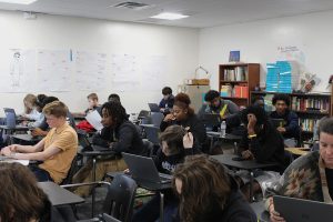 Students in teacher Elizabeth Halstead's seventh period Pre-AP English 2 class work on their essays on December 9.