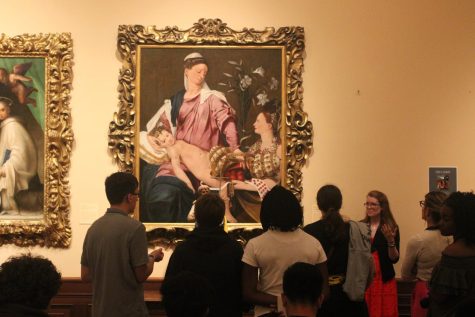 Onlookers observe a medieval painting on an art field trip on Feb. 20, 2018.