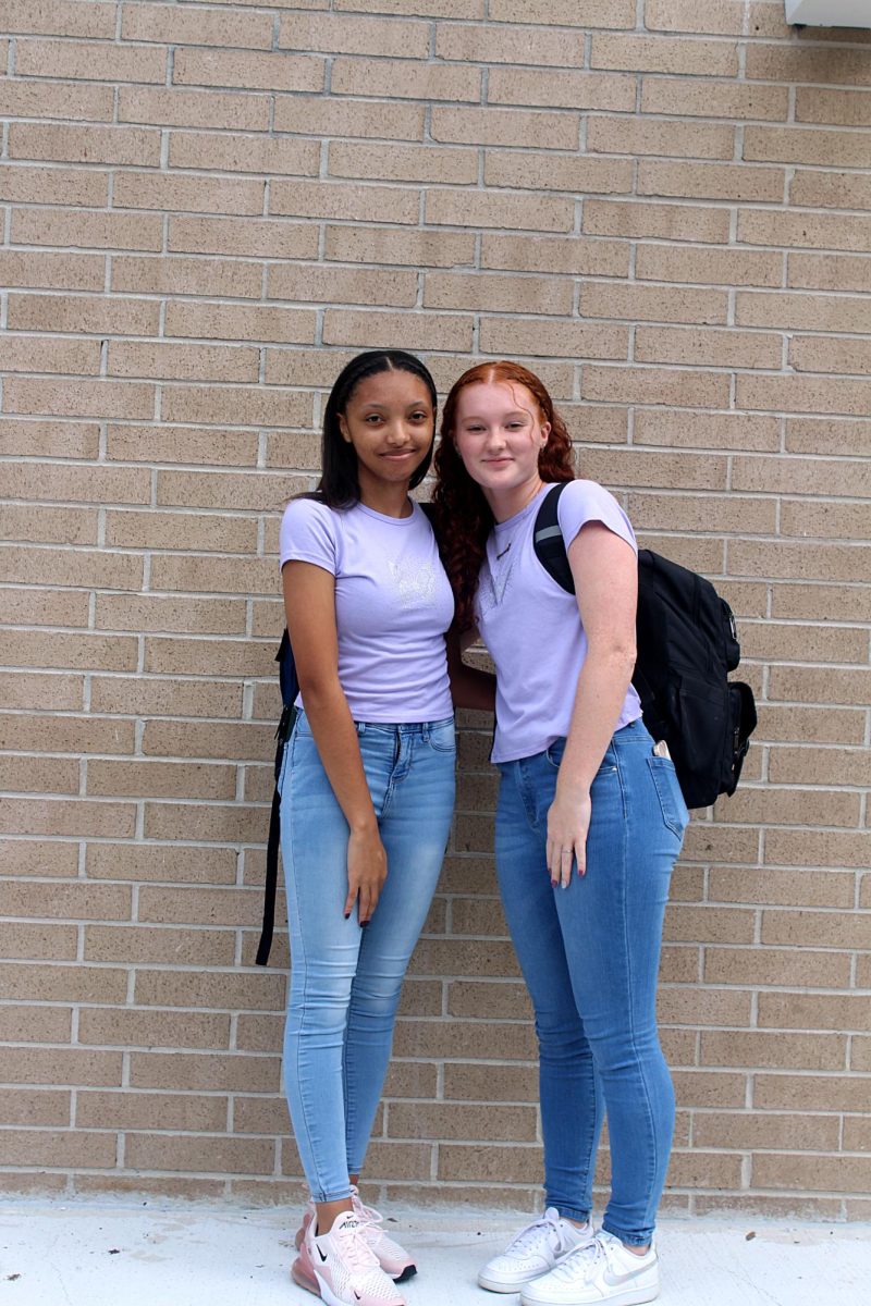 Senior Amya Washington and Junior Kenzy Webb pose on the stage in between A and B wing. 