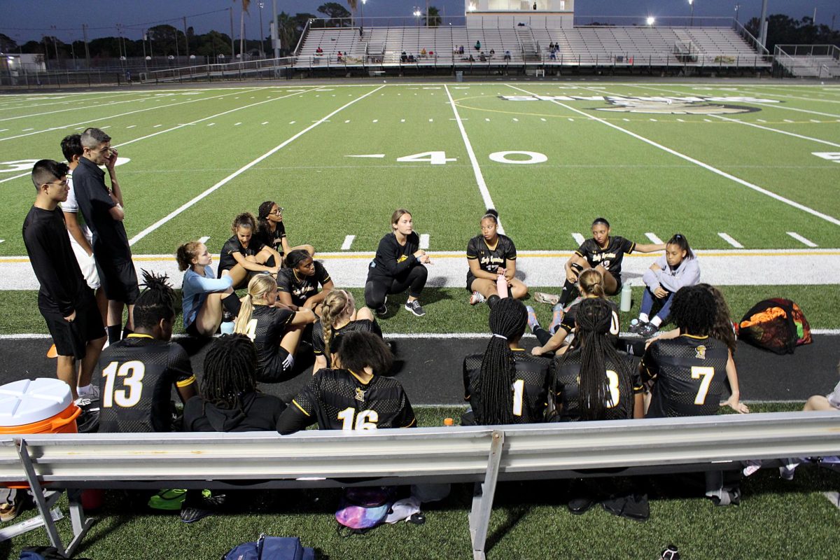 The girls soccer team sits as there coach talk to them at halftime. The girls were up against Booker 2-0 at halftime.