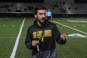 Coach Noah Coons directs his team on the field. Coons is the head coach for soccer at Lakewood High School. 