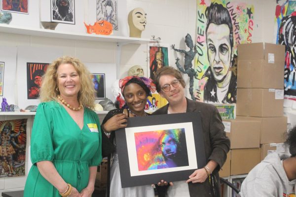Cora Ross poses with her artwork along with Art Teacher Adam Turkel and Gasparilla Art Festival Coordinator Cindy German. 
