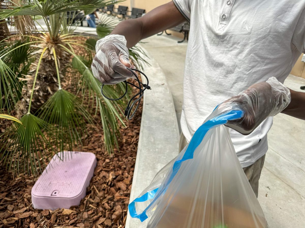 Senior Imran Barrow finds a charger in the bushes of the Main Hub Sept, 18. This was during one of Key Clubs weekly cleanups.