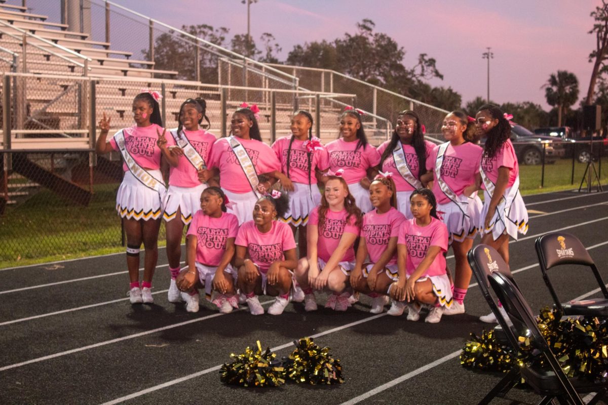 The Lakewood High School varsity cheer team poses for a photo during the Homecoming game on Oct. 18. The Spartans are clad in pink to show breast cancer awareness, which 1 in 8 women develop in their lifetime.