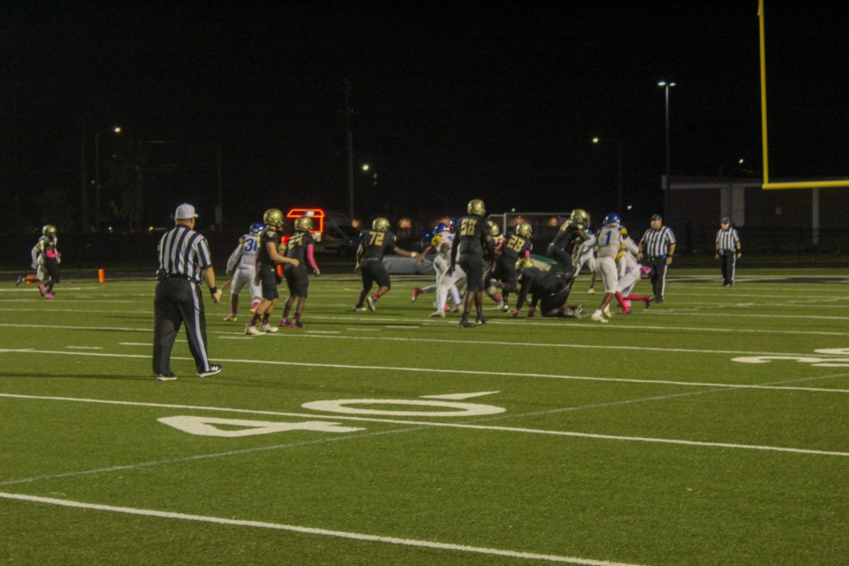 The Lakewood football team runs a play and scores a touchdown on the Spartan football field.