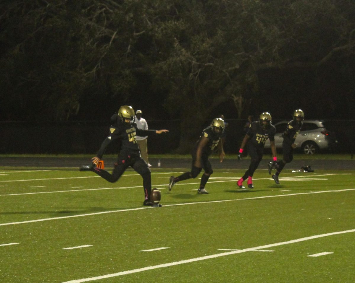 Junior Cole Sosa-Jones starts off a match with a punt to a football.