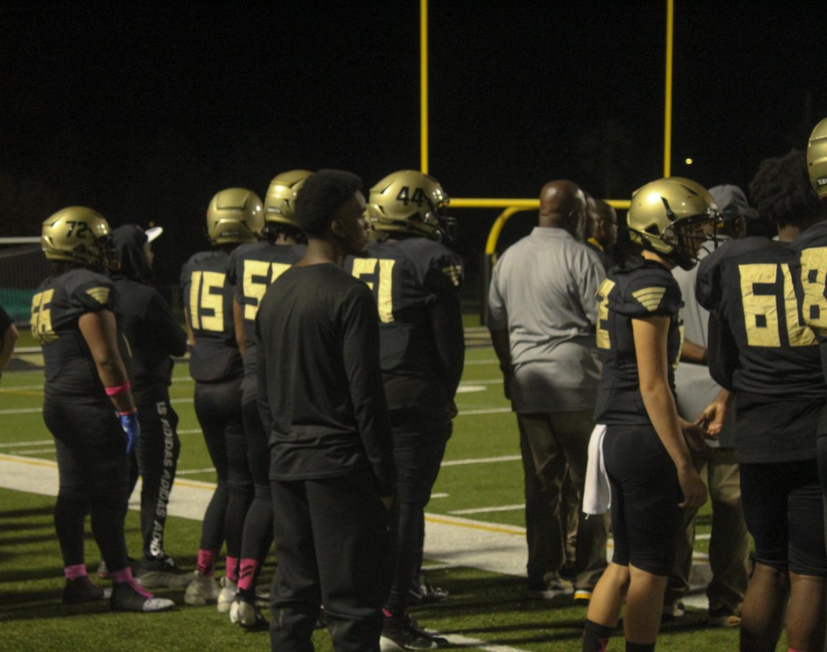 Our Spartans on the sidelines watch and support the other players on the field 