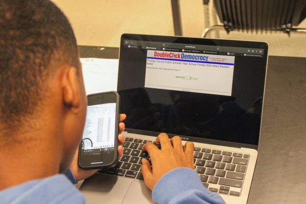 Senior Jaylin Keith enters voter ID into the mock election link Nov. 5. Students got a chance to participate in a mock election to teach them about how polls work. " It was a pretty easy voting process," Keith said.