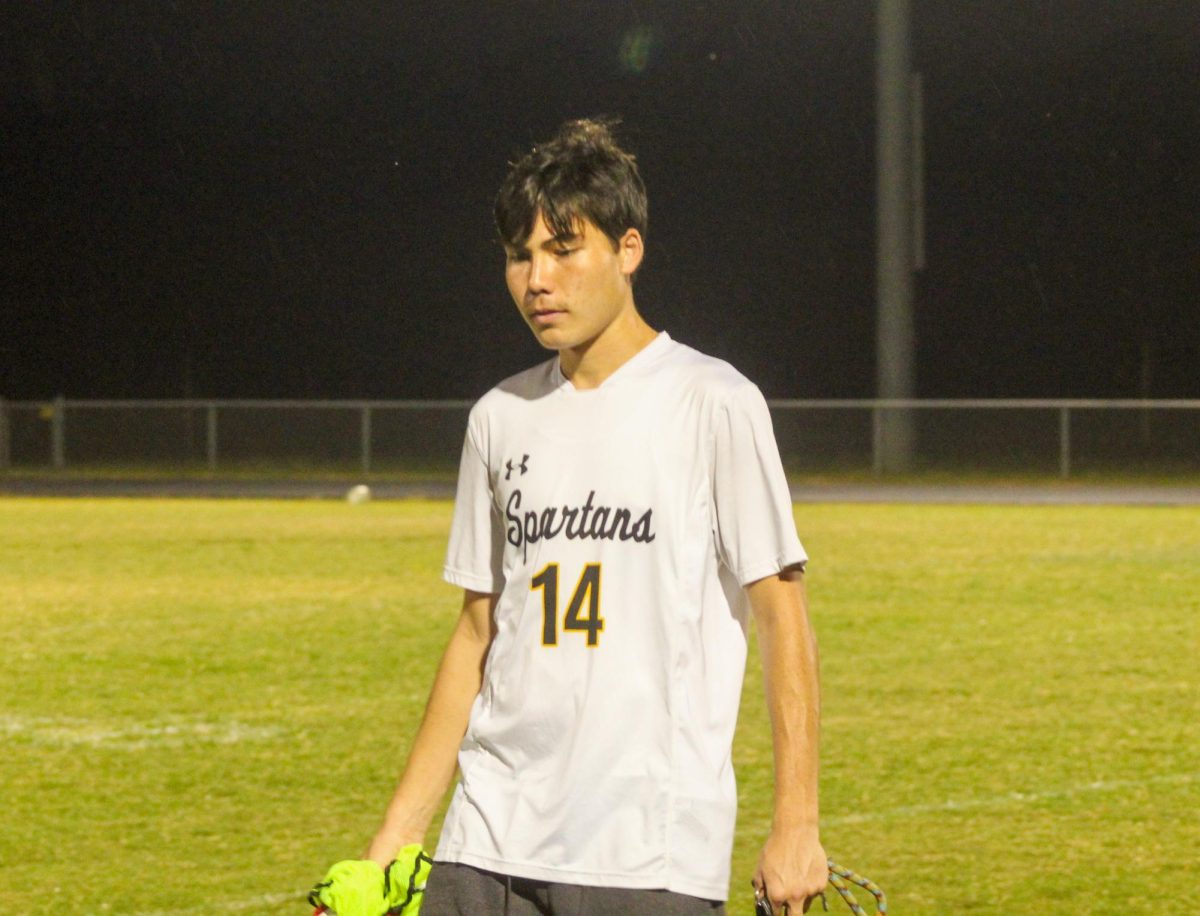 Senior Garyn O'Gradney walks to the sidelines while mentally preparing for the soccer game