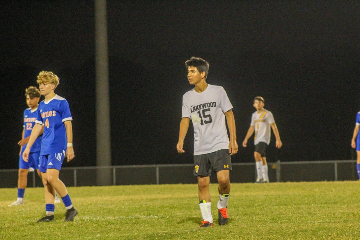 Freshman Haasan Sharifi watches one of the Osceola players do a throw in to prepare to steal the ball.