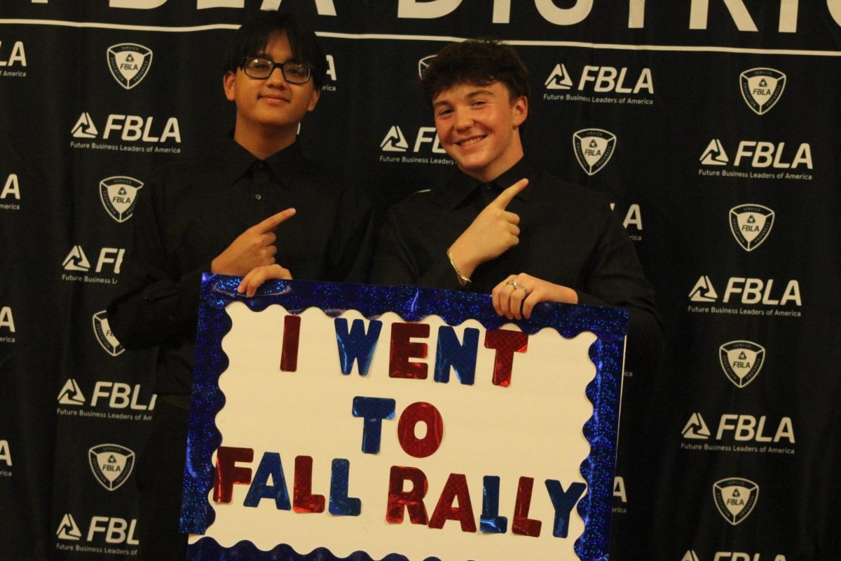 Juniors Jayden Ngyuen and Griffin Smotzer pose with the sign made by Lakewood FBLA students.