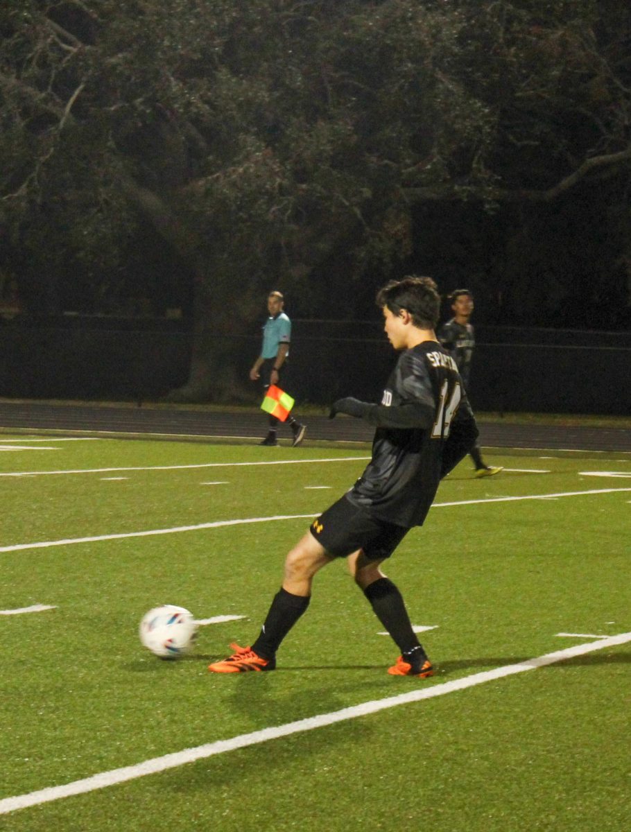 Senior Garyn O'Gradeny passes the ball back to the goalie so that the goalie can punt the ball.