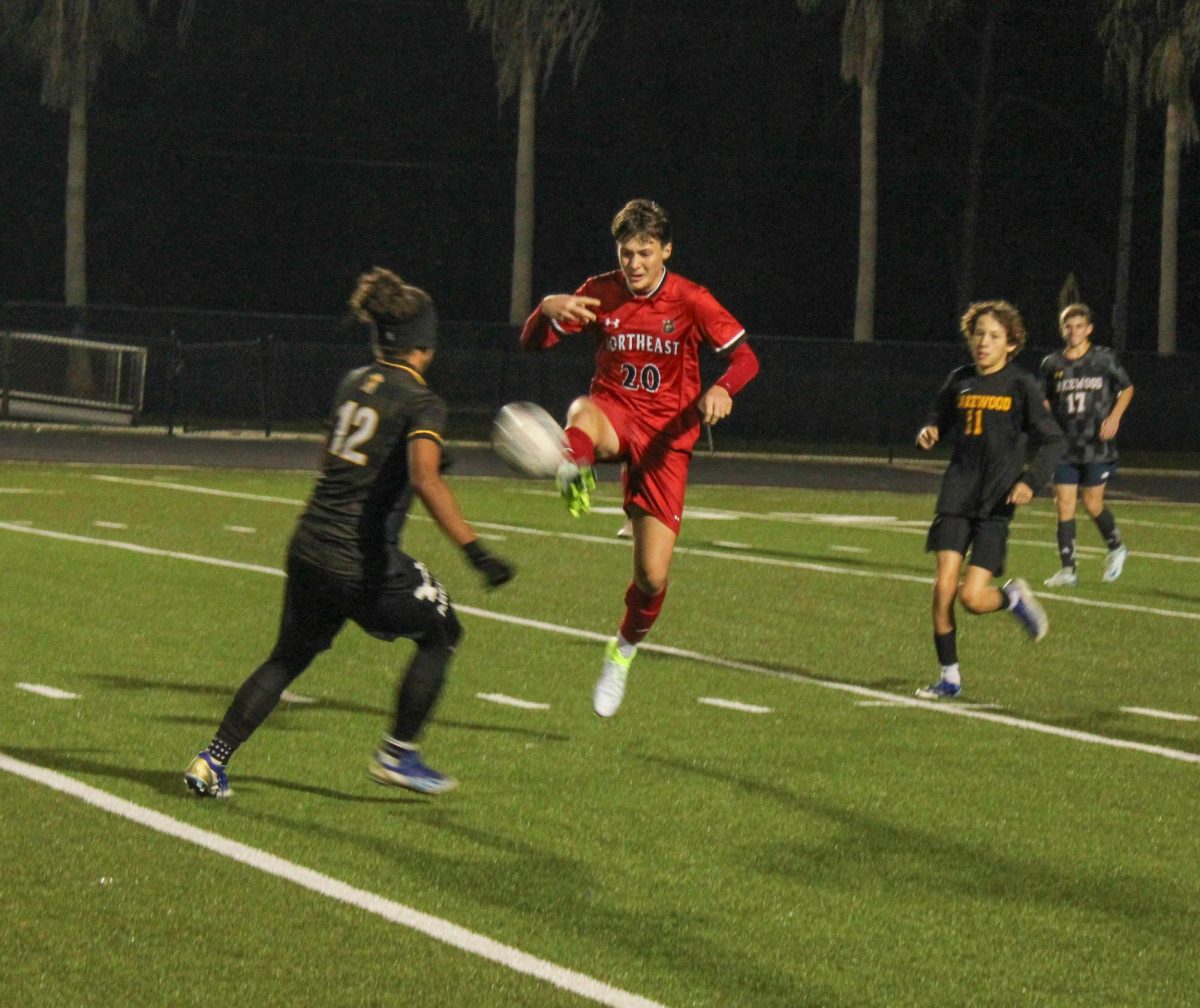 Freshman Isael Caraballo defends and guards the ball from the opponent passing the ball to the opposing teammates.