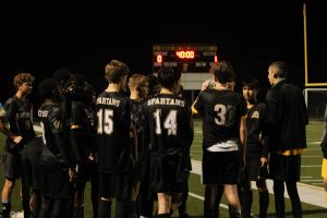 Our very own Lakewood Spartans stand on the sideline while getting talked to by Coach Matthew Cortez.