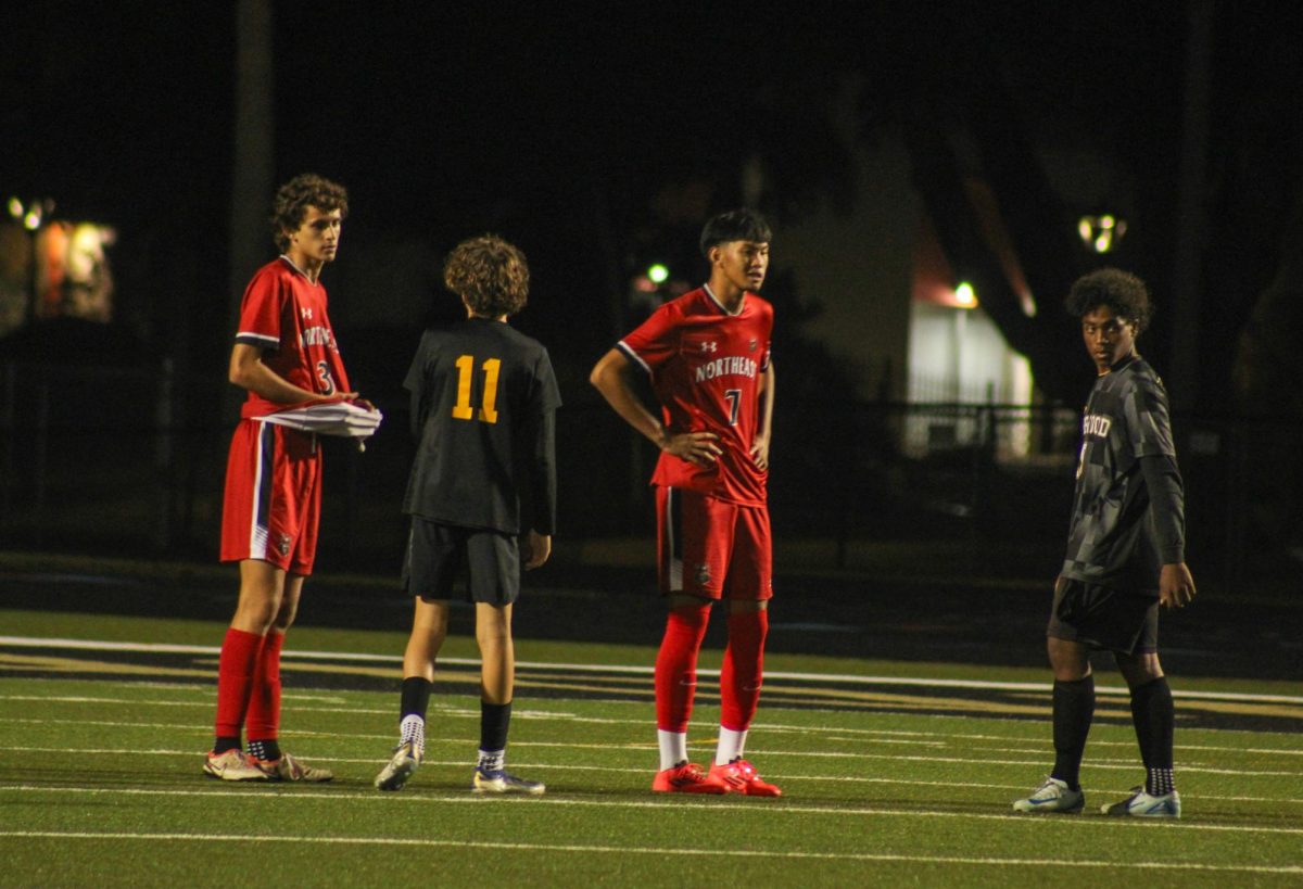 Lakewood Spartans stand on the field to defend the goal against the opposing team.