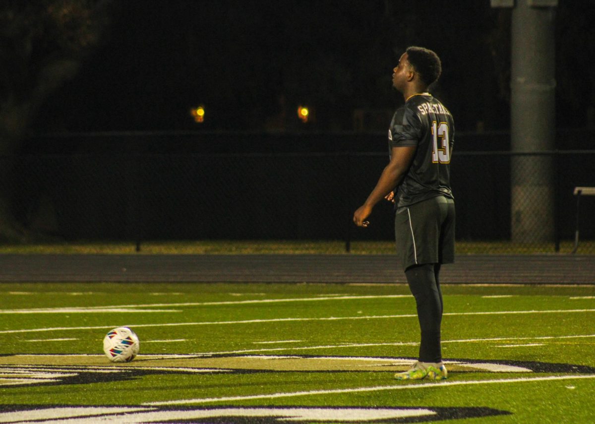 Senior Jeremiah Eustache prepares to kick the ball towards his teammate to get a play started.