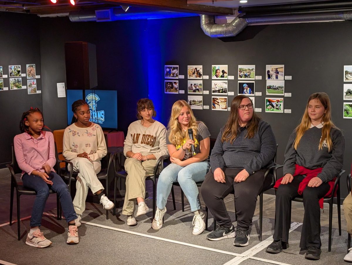 Students sit with Alex Mahadevan to speak to the audience about their photography.