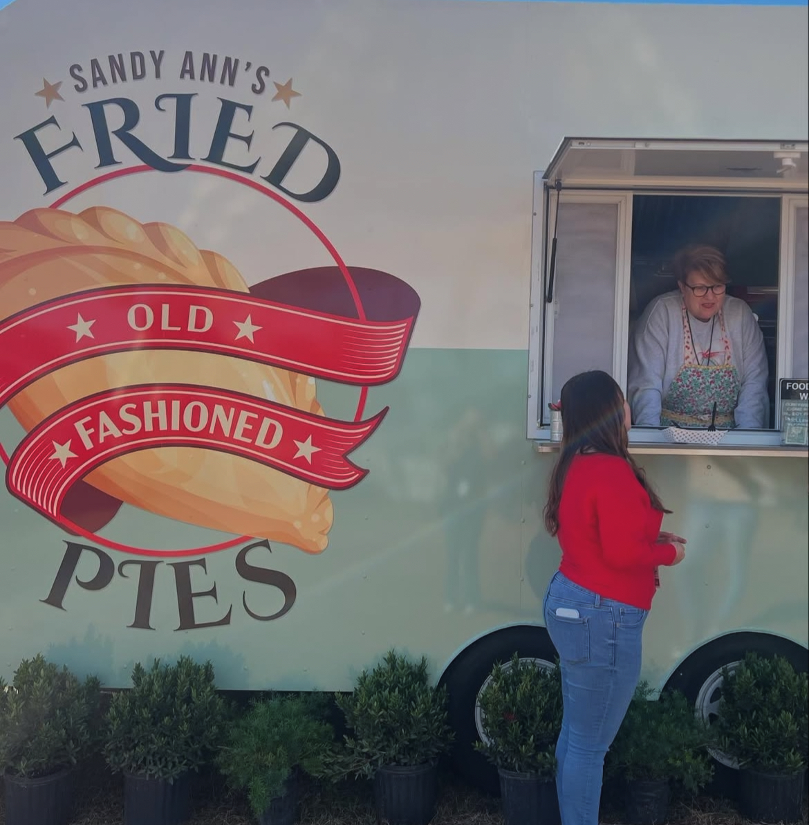 Senior Jules East interviews Sandy Ann's Fried Pies food truck owner Sandy Boggs at the Strawberry Festival. 