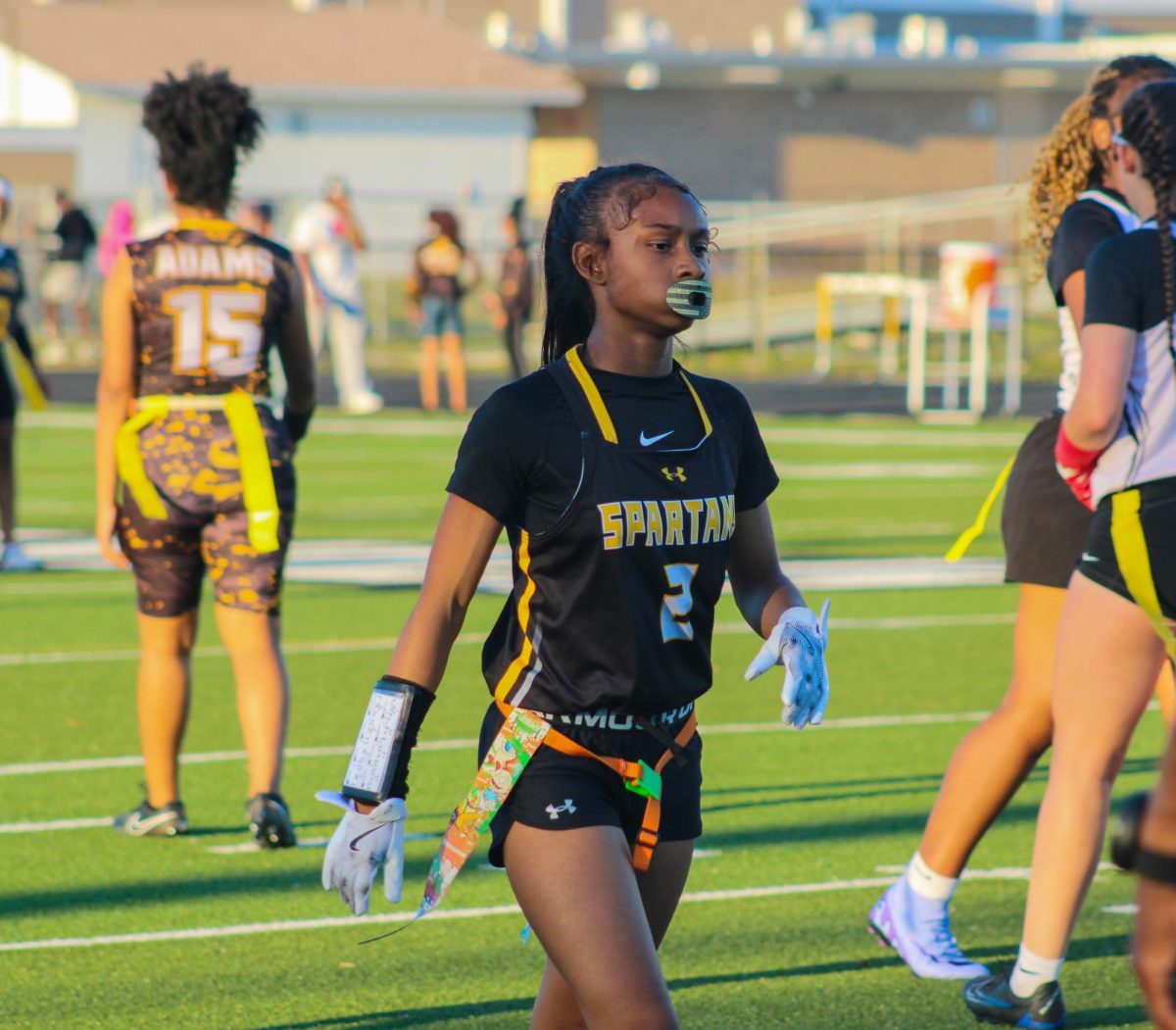 Sophomore Nilah Mcqueen stands on the line as she prepares to defend the Quarterback on Mar. 11th on the Lakewood Football field.