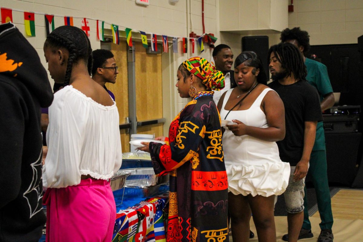 Seniors stand in line at the senior breakfast receiving their delicious breakfast made by teacher Delia Doss.