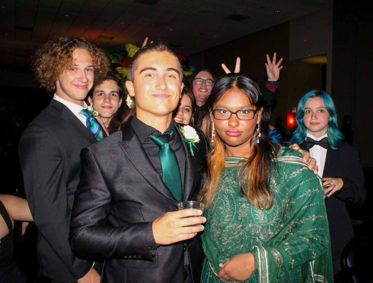 Lakewood High School students  senior Keegan Cunnigham and junior Saima Akter pose for group photo on May. 3 in the USF St.Petersburg Ballroom for prom 2025