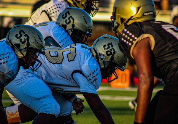 Sophomore Terrell Holmes waits for the quarterbacks call to hike the ball to start the play. "I was surprised of how even though defensive line was holding their own offense kept fighting and started coming back at the end." says Holmes 