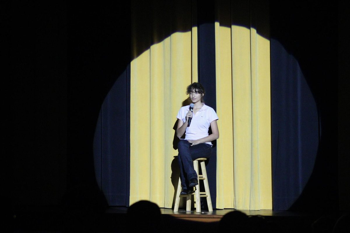 Lights pan to junior Irene Laclaustra before she sings 'Anxiety' by Doechii. Laclaustra is the president of the drama club.