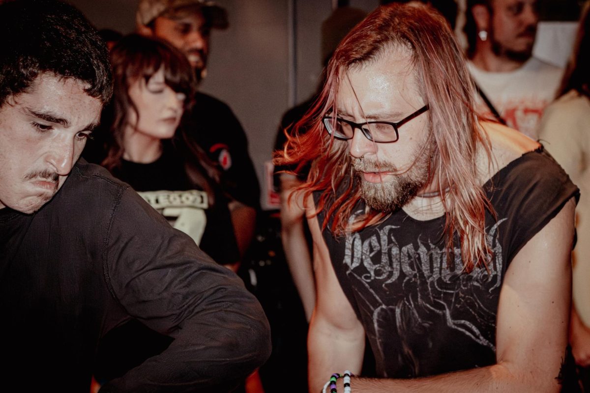 People two stepping to Flag Burner in the mosh pit on Aug. 23 at Deviant Libation. Two stepping is a style of dance that mothers do durning the breakdown of a song. 