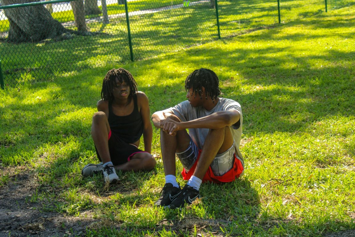 Senior Amari Barnes and Sophomore Marcus Hamilton discussing the workout at Track and Field practice held at Lake Vista park on September 30.