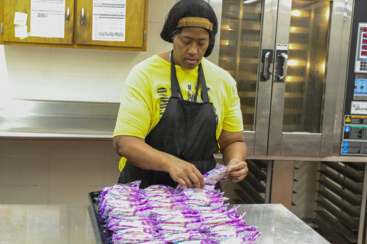 Lunch Lady Morvin Henry Puts Peanut Butter Jelly Sandwiches inside of a tray "The kids will love this."  Picture Taken by Jesean Scott Lakewood SNN Photographer