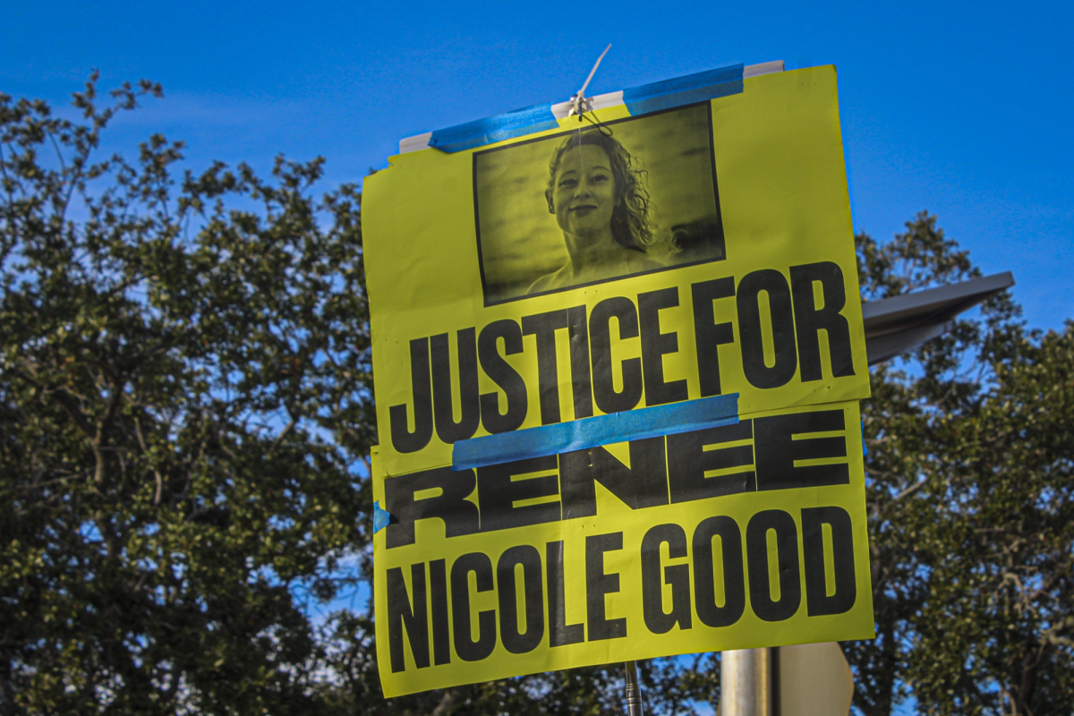 A sign that reads "Justice for Renee Nicole Good" is held up on Jan.12 in Protest of ICE in front on the Hilton Carillon which hosted a Border Patrol recruitment fair. Renee Good was fatallyshot by an ICE officer in Minnesota eariler this month.
