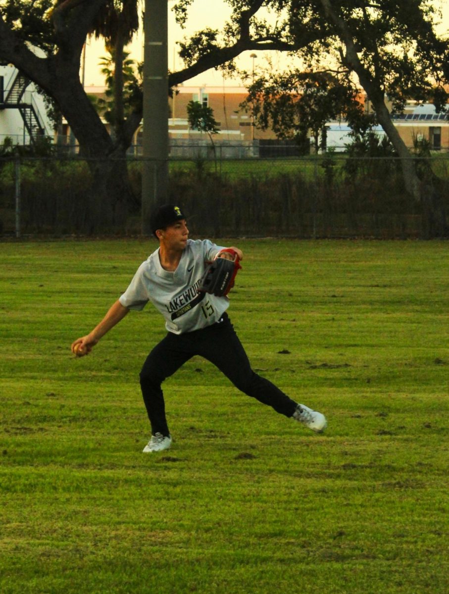 Freshman Siam Sinchat throws the ball to his teammate. The Lakewood Baseball team played against Largo High School on Friday, Feb. 20 at Lakewood High School's baseball field.