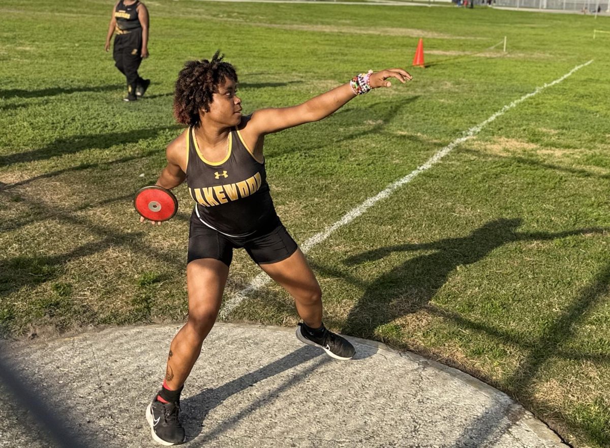 Senior Tatyana Wooden prepares to launch the discus during her competition. Wooden has been doing track and field for all four years.