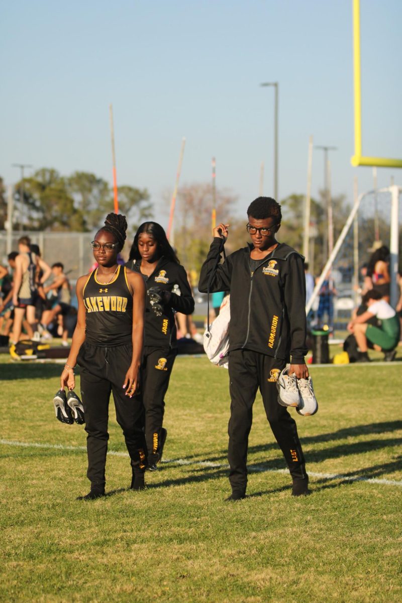 Lakewood High School track team athletes' sophomores Jada Howard, Cherish Harrigton, and senior Amari Barnes walk across the field. On April 2 the track team had a track meet against Largo and Boca Ciega High School.
